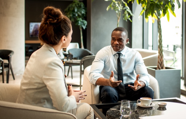 man-and-woman-speaking-in-office-setting